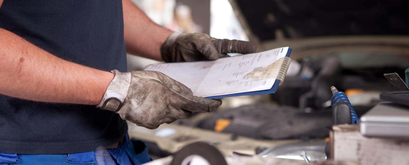 mechanic holding papers