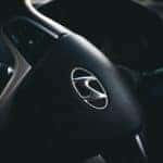 A close up of the Hyundai logo on a steering wheel of a 2023 Hyundai Sonata Hybrid