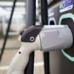 A plugged in electric Hyundai vehicle at a charging station.