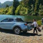 A couple loading up a 2024 Hyundai Santa Cruz after a day at the lake