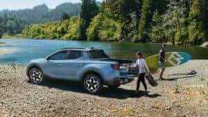 A couple loading up a 2024 Hyundai Santa Cruz after a day at the lake