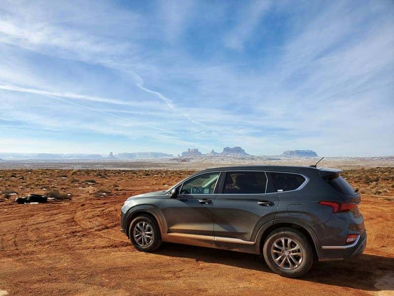 SUV parked on a dirt road in the desert