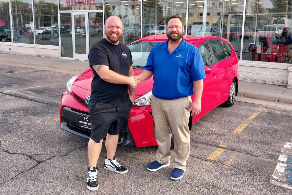 sales consultant kris wolfe delivering a toyota prius