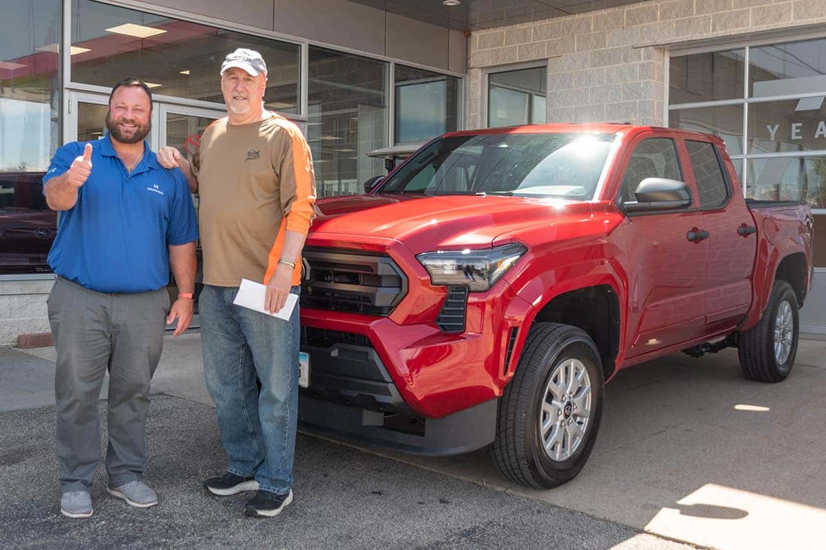 sales consultant kris wolfe delivering a new toyota tacoma