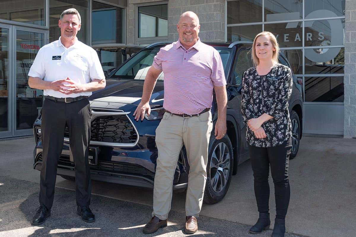 Sales Consultant Chris Ludescher and sales assistant amber schmitt delivering a toyota highlander at Anderson-Weber Toyota in Dubuque Iowa