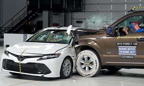 an iihs crash test of a ford truck crashing into a toyota camry