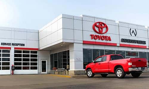 a photo of a red tundra in front of anderson-weber toyota located in dubuque iowa
