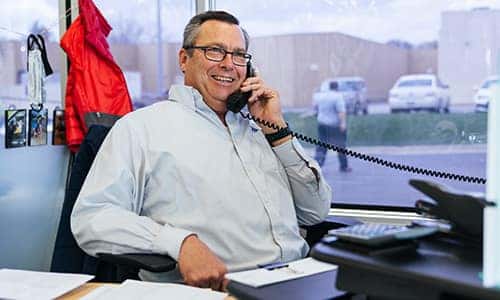 a sales consultant at anderson-weber toyota talking on the phone with a customer