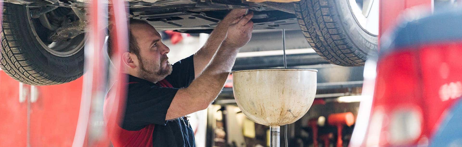 a toyota certified technician performing an oil change at anderson weber toyota