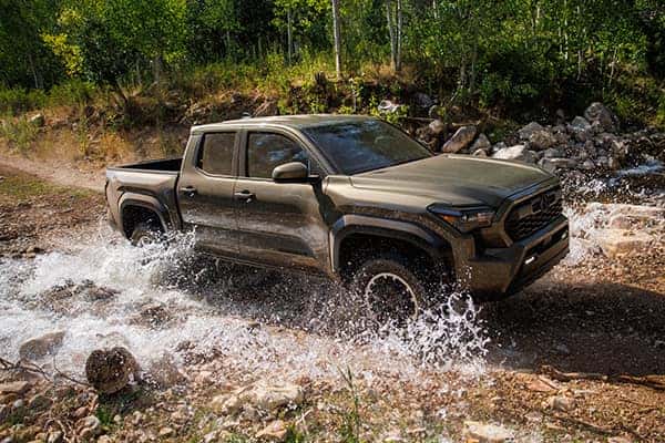 a brand new tacoma driving through water