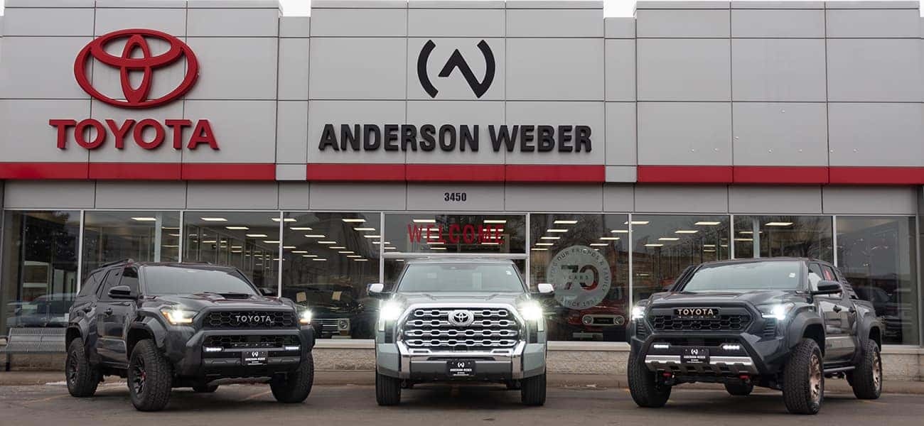 a brand new toyota tundra tacoma and 4runner in front of anderson weber toyota in dubuque iowa