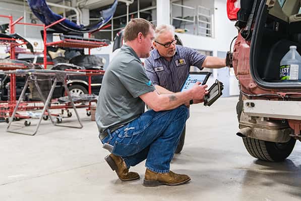 body shop employees working in abra auto body apart of anderson weber toyota