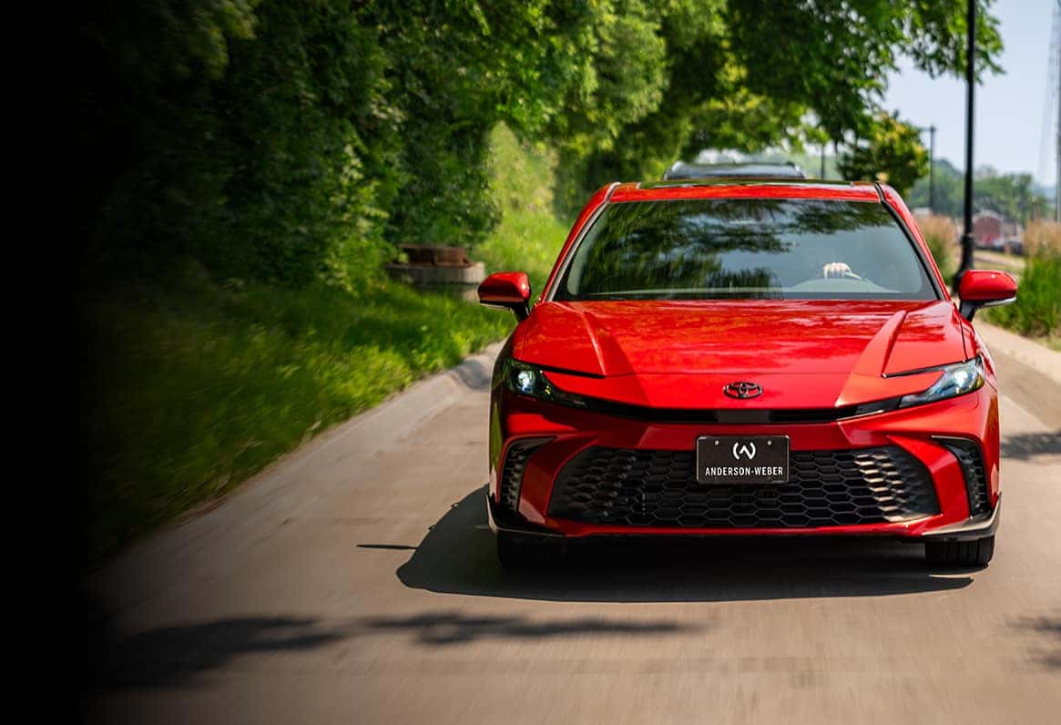a brand new red toyota camry from anderson weber toyota driving
