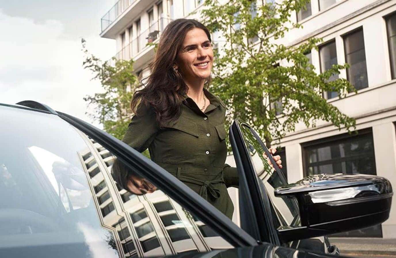 Woman walking in front of a BMW