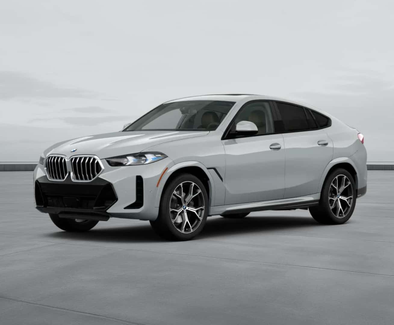 2027 BMW X6 parked on a concrete surface against a cloudy sky.