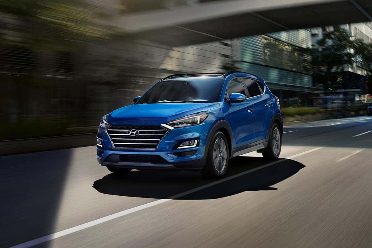 Boch Hyundai is a Hyundai Dealer Near Canton MA | Bright Blue 2020 Tucson Driving Through City