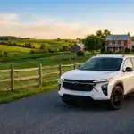 White Chevrolet SUV parked on a paved country road next to a wooden fence with rolling green hills in the background. (Representative image for illustration purposes only. Actual vehicle may vary based on trim and configuration.)
