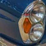 A blue vintage car is shown in close up after searching "sell my car."