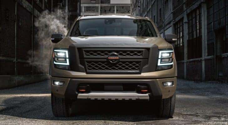 A brown 2022 Nissan Titan parked in an alley, facing the camera