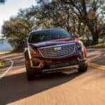 A red 2019 Cadillac XT5 is shown driving after visiting a used SUVs near Chapel Hill.