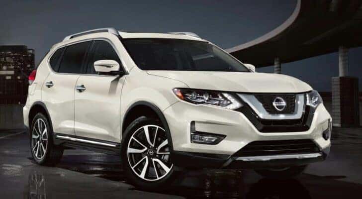 One of many popular used SUVs for sale, a white 2020 Nissan Rogue, is shown parked.