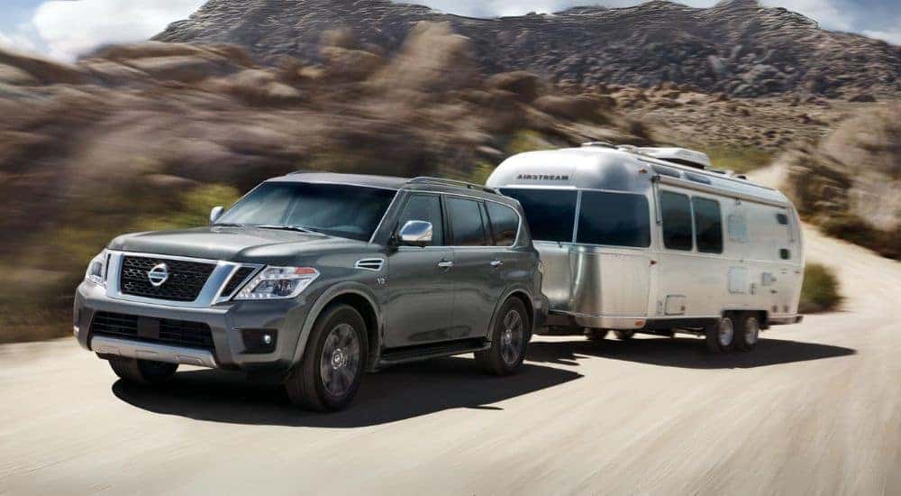A grey 2018 Nissan Armada is shown towing an Airstream after looking at used cars for sale near Chapel Hill.