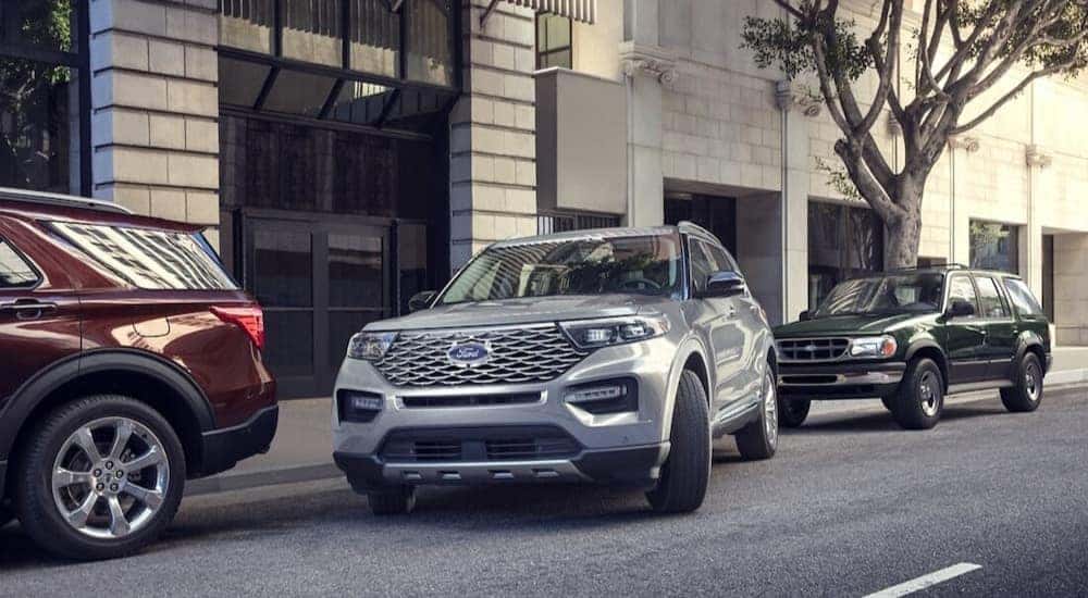 A silver 2023 Ford Explorer is shown using parking assist near used cars for sale near Durham.