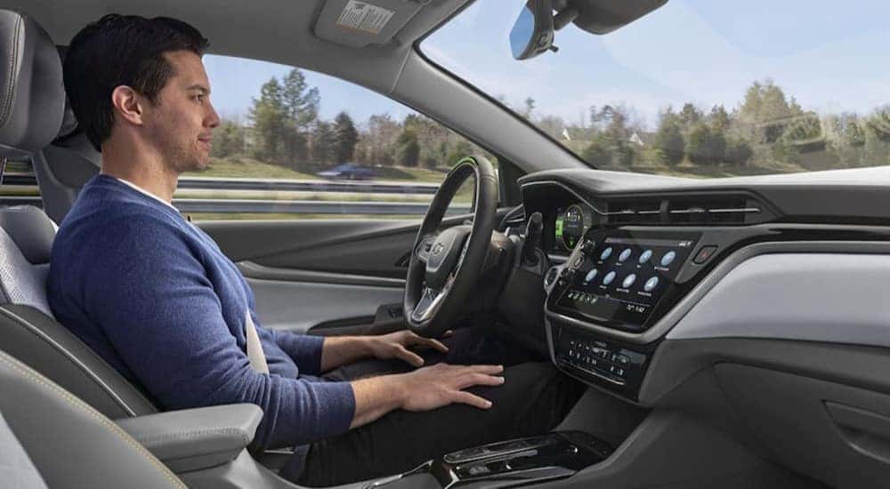 A person is shown using Chevy SuperCruise in a Chevy vehicle.