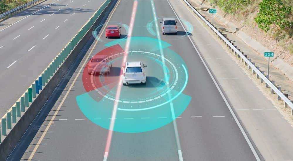 Vehicles are shown driving on a highway with simulated safety circles.
