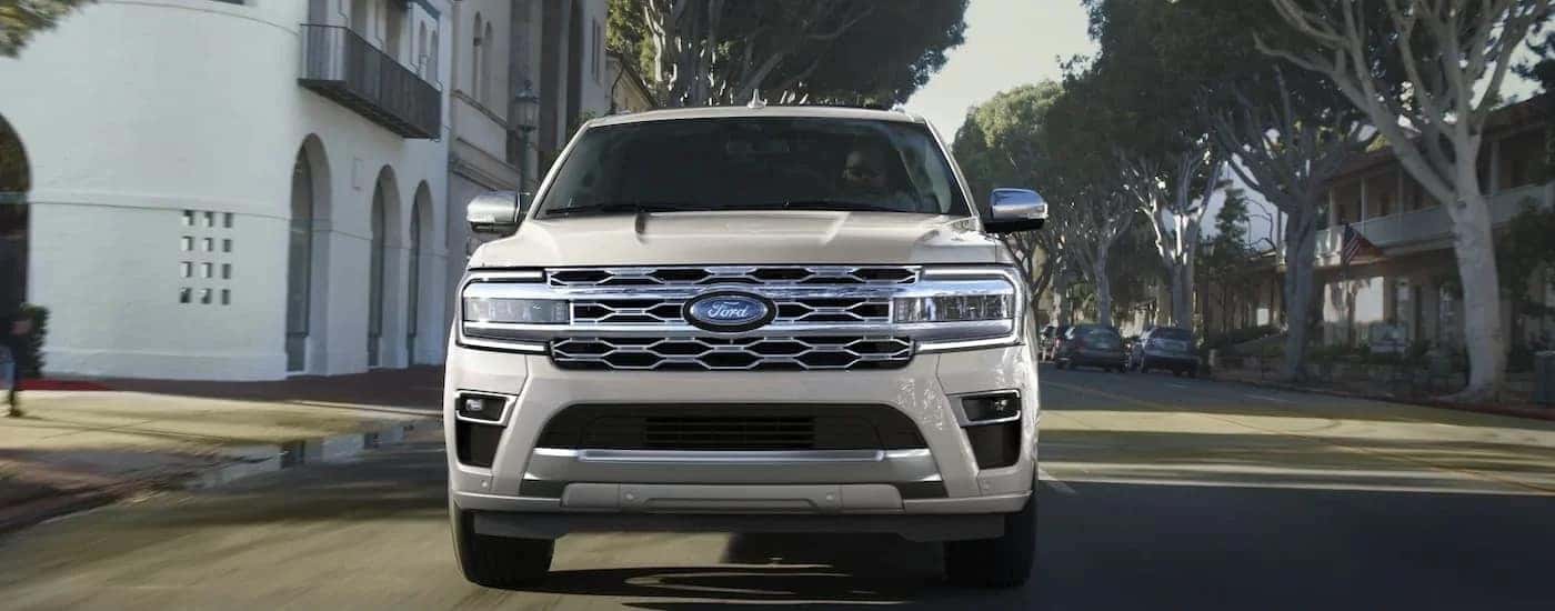 White 2022 Ford Expedition Platinum driving on a downtown road