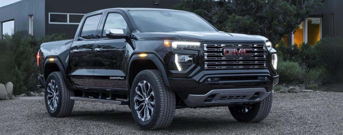 A black 2023 GMC Canyon Denali is shown parked after viewing used trucks for sale near Mebane.