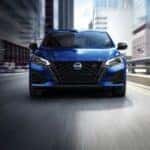 A blue 2023 Nissan Altima SR is shown from the front after leaving a used car dealership.