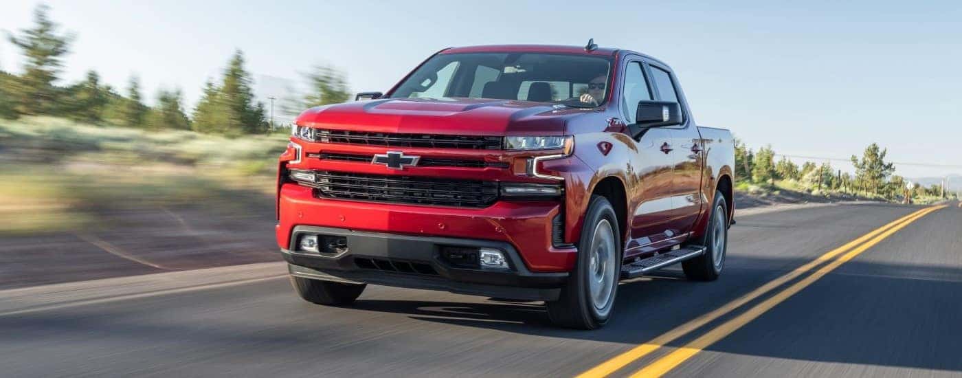 Red 2020 Chevy Silverado 1500 Z71 driving to a used car dealership near Mebane