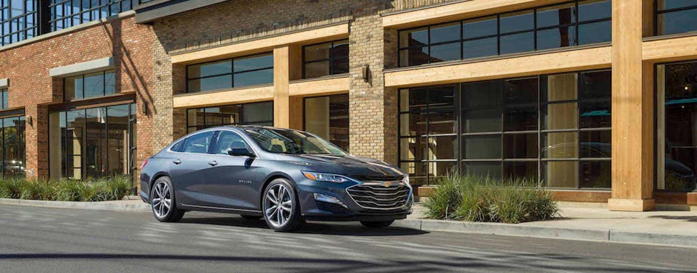 A grey 2021 Chevy Malibu parked on a street.