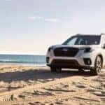 A white 2023 Subaru Forester on a beach after leaving a car dealership in Hillsborough.
