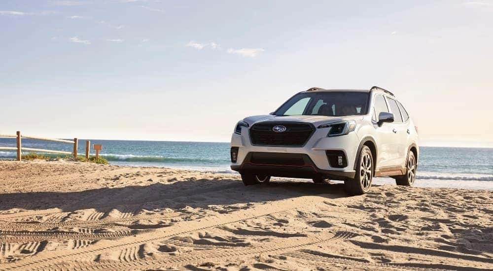 A white 2023 Subaru Forester on a beach after leaving a car dealership in Hillsborough.