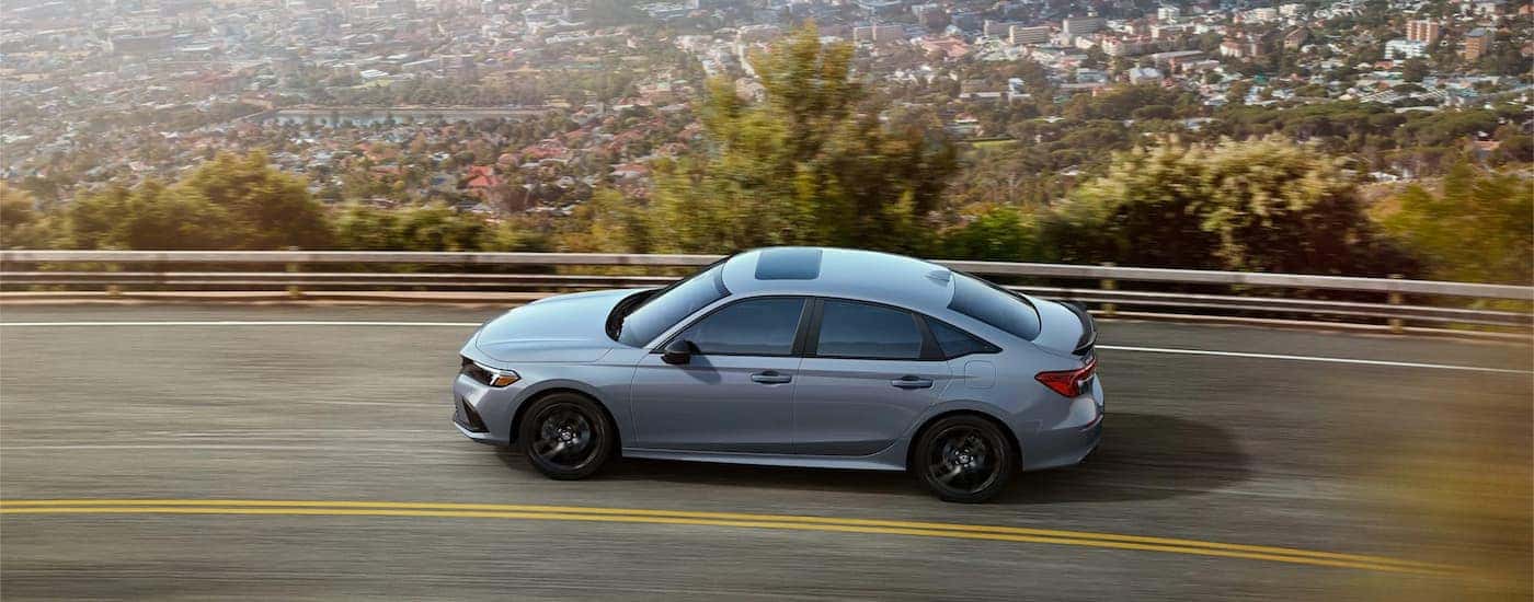 A gray 2022 Honda Civic SI driving on a highway