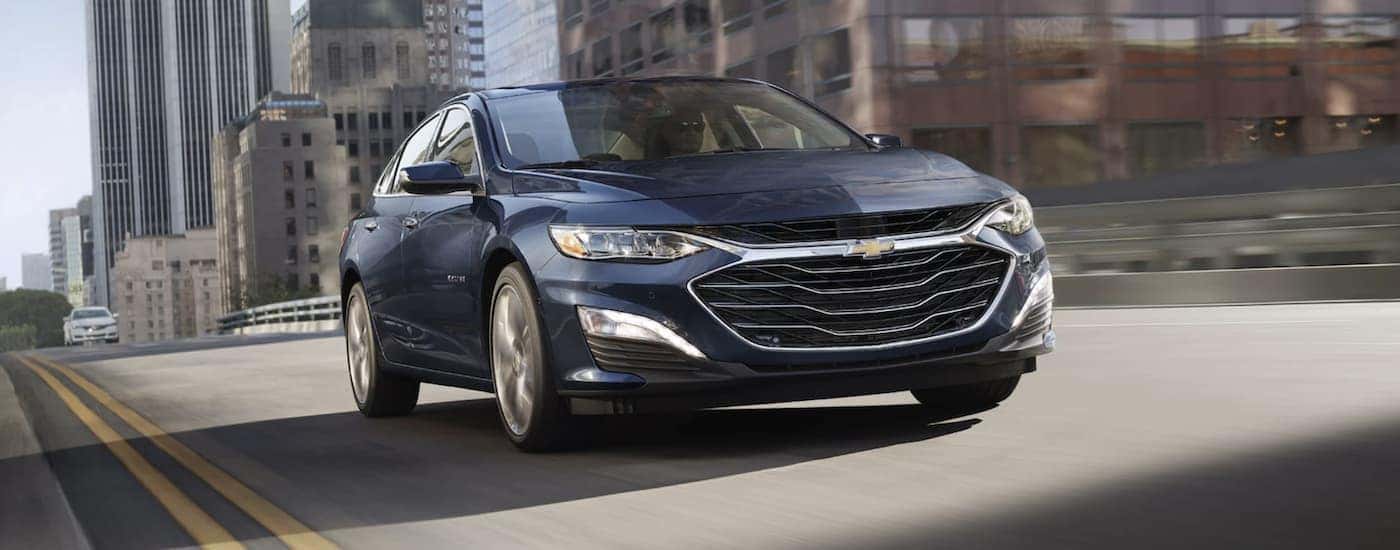 A dark blue 2022 Chevy Malibu from a car dealership in Roxboro