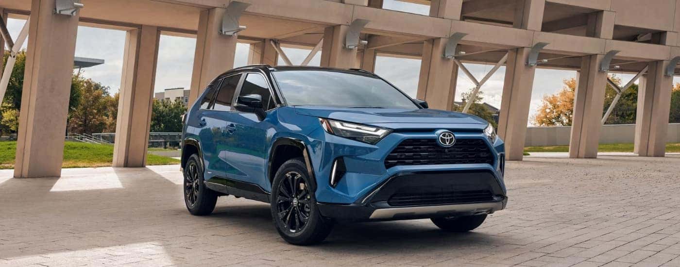 A blue 2024 Toyota RAV4 from the front at an angle.
