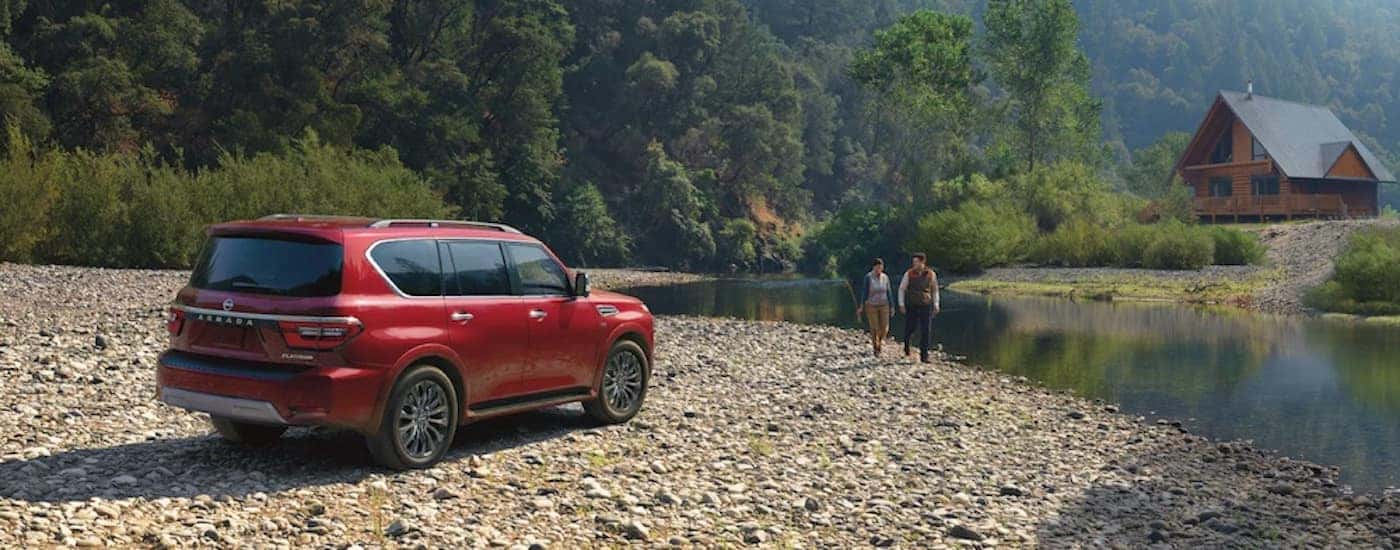 A red 2022 Nissan Armada from the side.