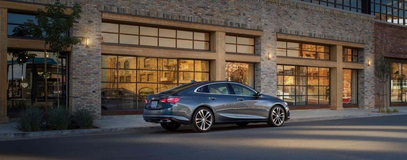 A grey 2019 Chevy Malibu from the side after leaving a used car dealer near Butner.