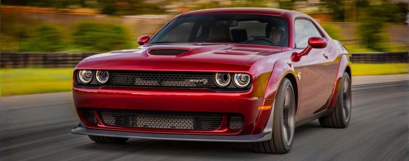 Red 2018 Dodge Challenger SRT Hellcat driving to a car dealership