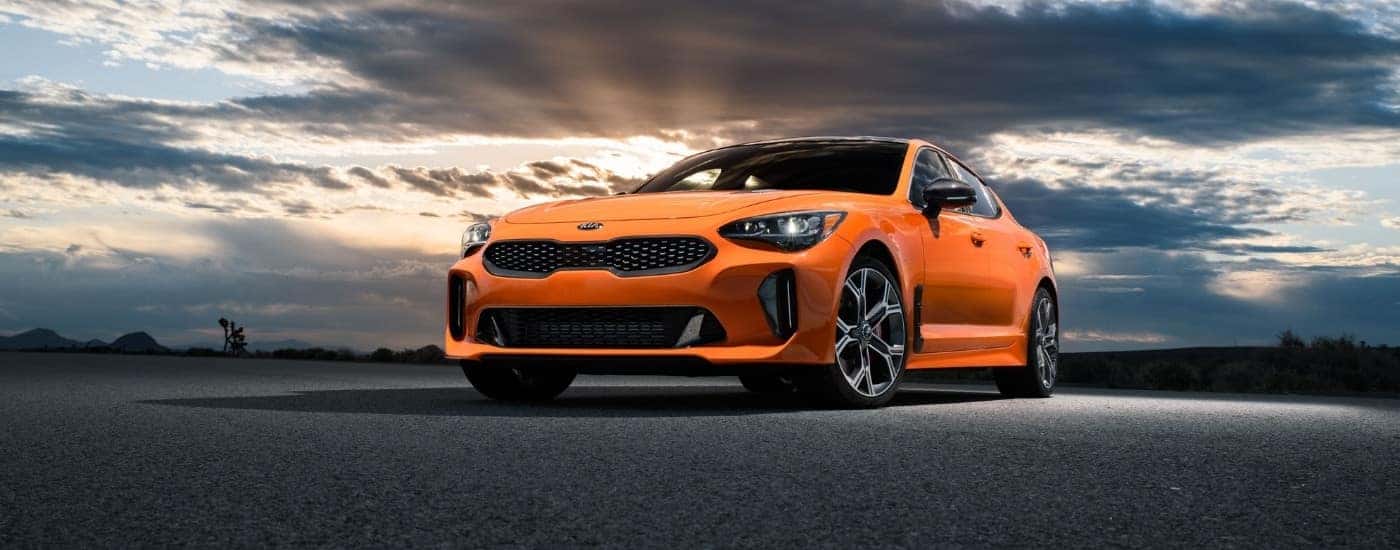 Orange 2020 Kia Stinger parked on pavement