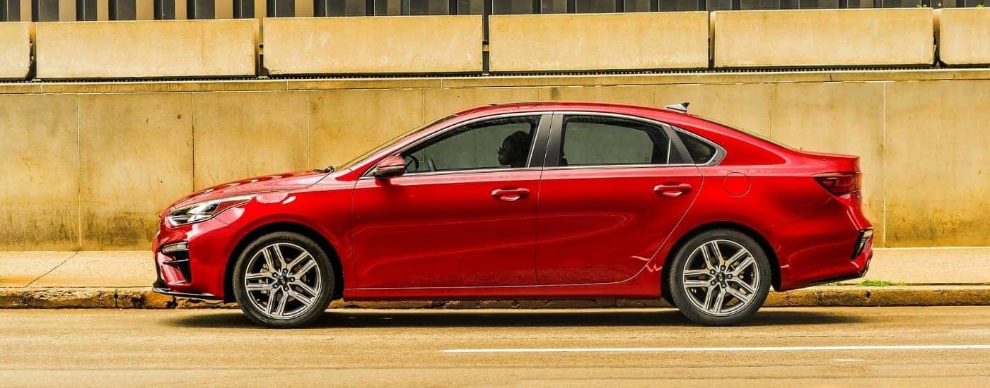 Red 2019 Kia Forte parked on a city street