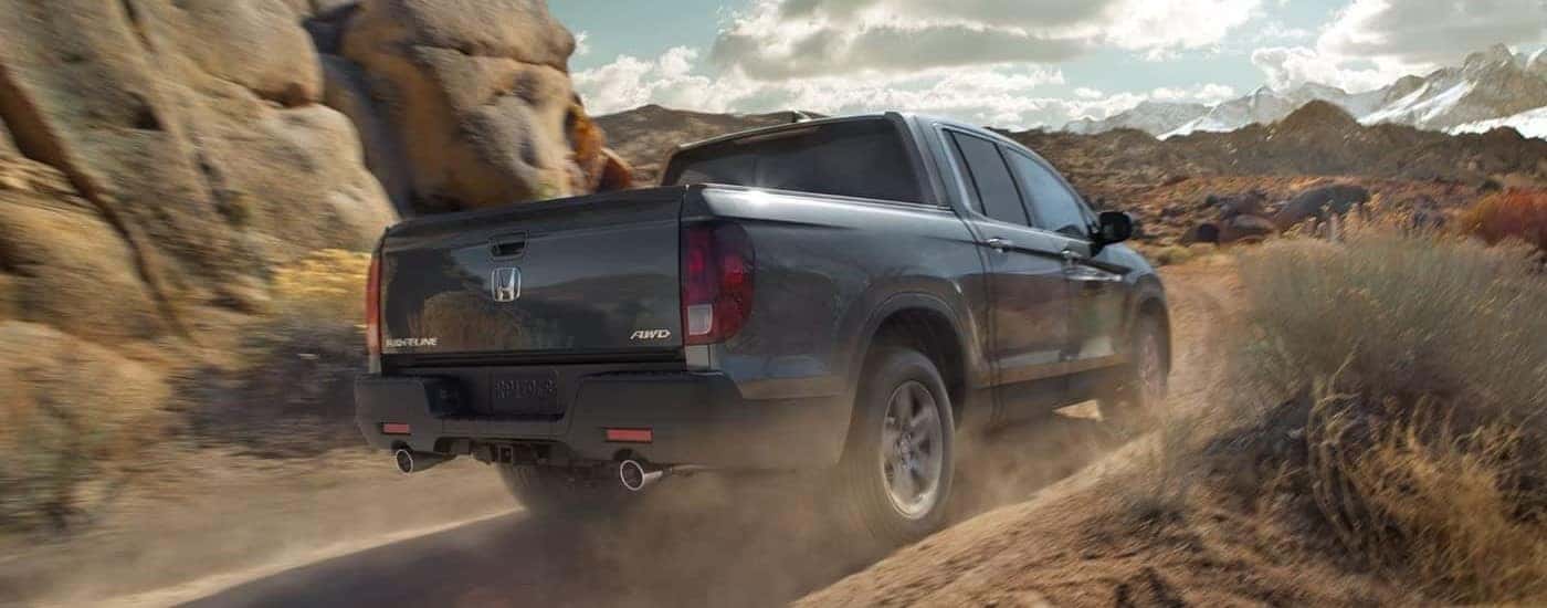 A gray 2023 Honda Ridgeline RTL-E off-roading on a trail