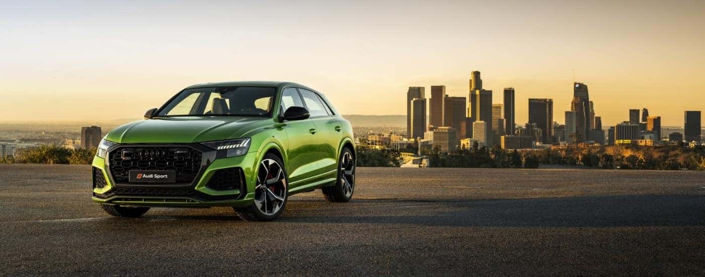 Green 2019 Audi RS Q8 parked outside a car dealership near Butner