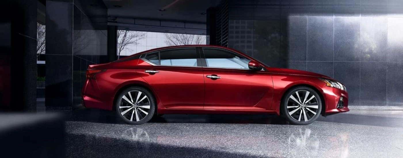 Red 2019 Nissan Altima from the side in a garage