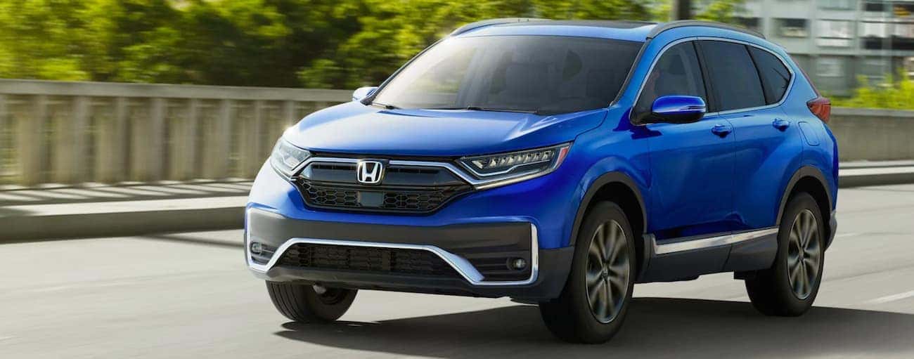 Blue 2021 Honda CR-V driving down the road