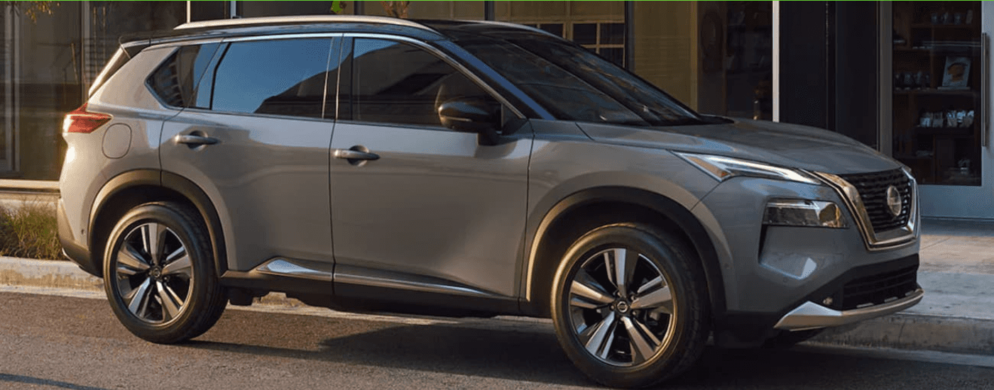 A grey 2020 Nissan Rogue is shown parked on a city street after looking at used cars in Durham