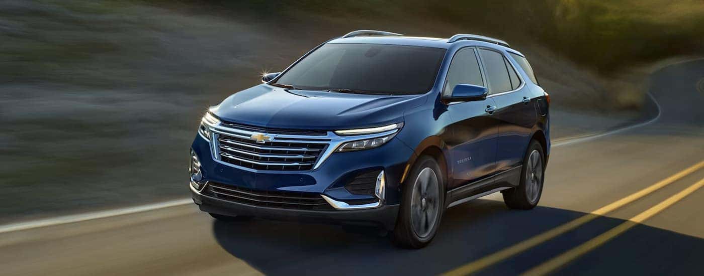 Blue 2022 Chevy Equinox driving down an empty road